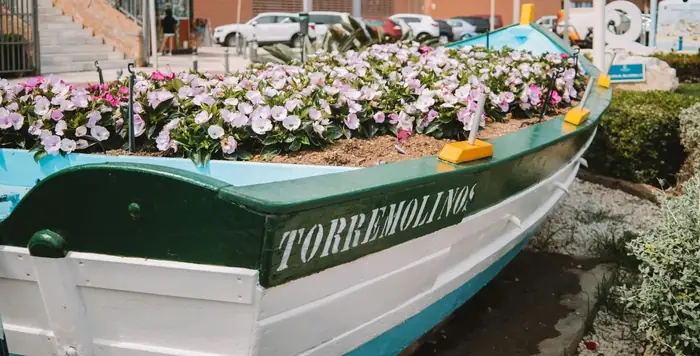 Traditional fishing boat with flowers in Torremolinos